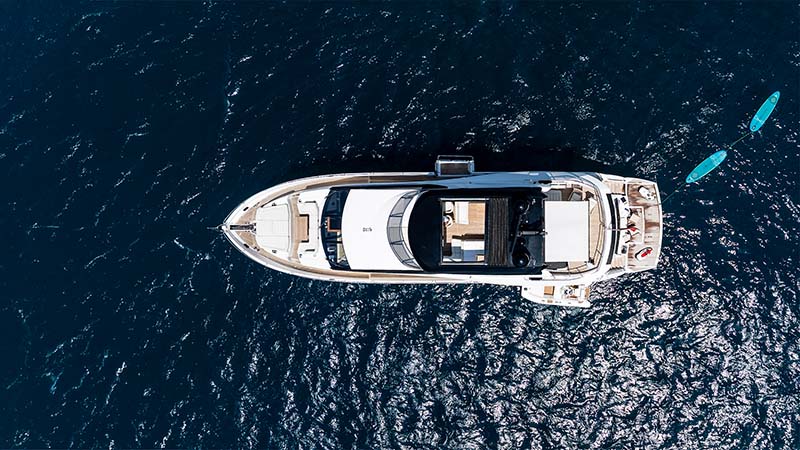 Aerial view of the Sunseeker 86 JUPJU under way with paddleboards astern